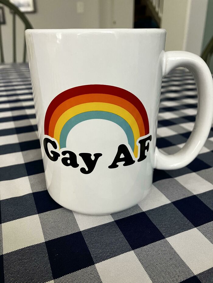 White mug with a colorful rainbow and bold text, showcasing a unique design for mug life enthusiasts.