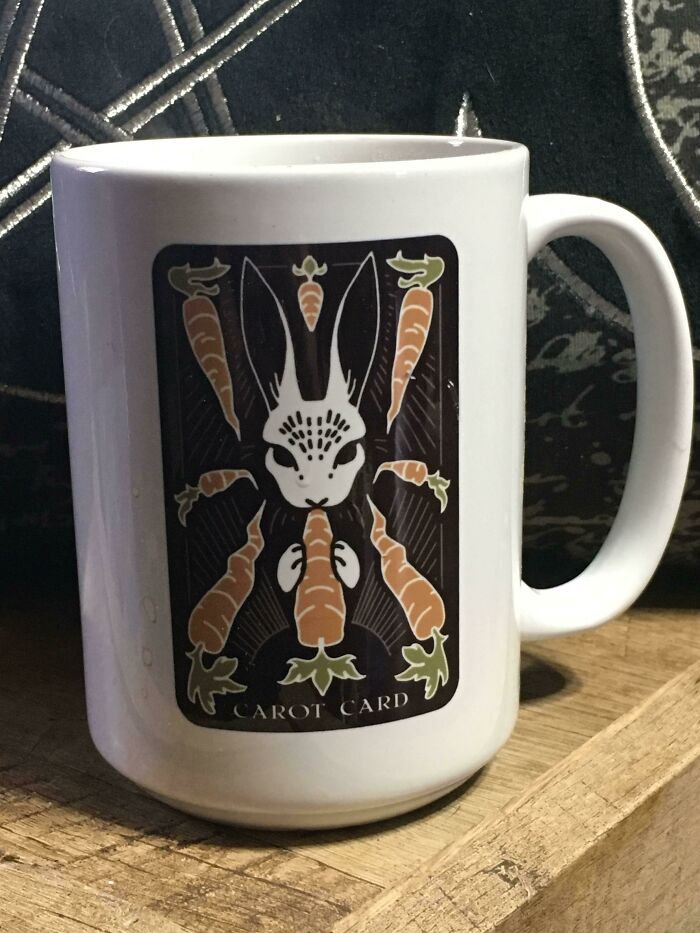 White mug with a graphic of a rabbit surrounded by carrots, featuring the words carrot card, showcasing mug life creativity.