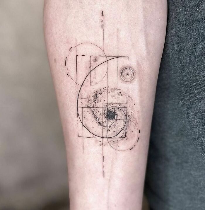 Science tattoo featuring a geometric galaxy design on forearm.