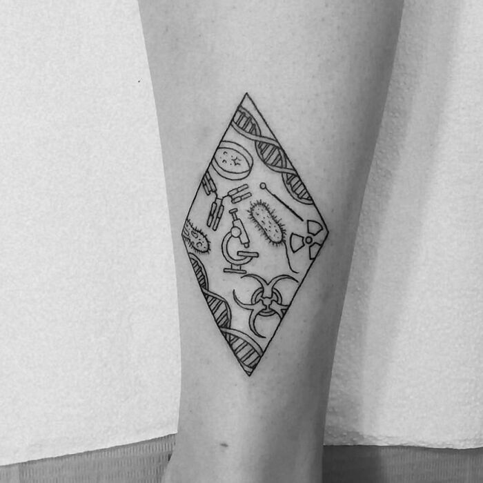 Diamond-shaped tattoo featuring scientific symbols like DNA, microscope, and molecules on forearm.