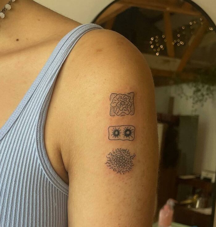 Science tattoos on arm showing microbiology designs, highlighting creativity and science.