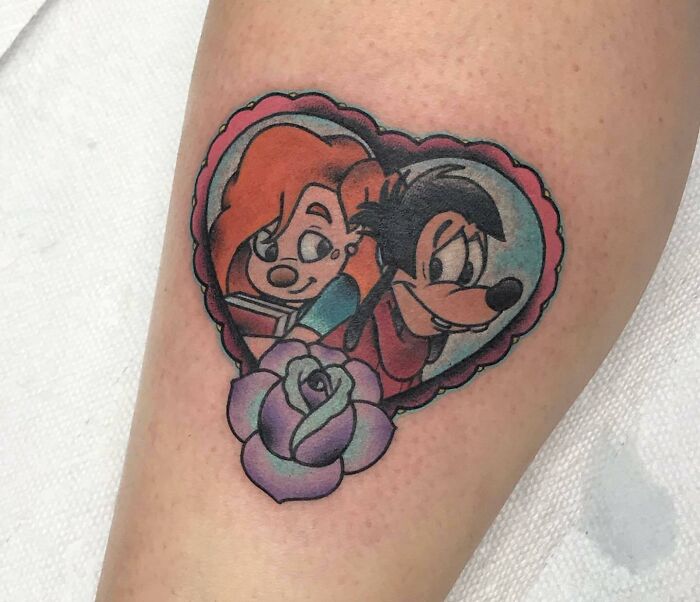 '90s tattoo featuring cartoon characters in a heart-shaped frame with a rose.