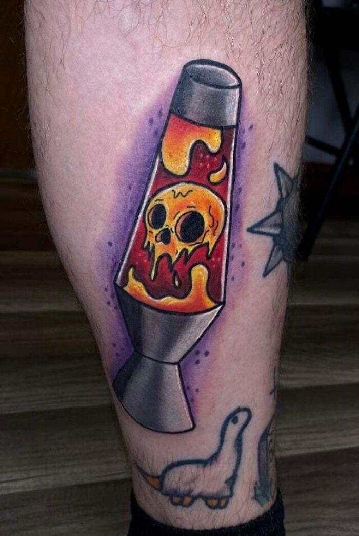 '90s tattoo featuring a colorful lava lamp with a skull design on skin.