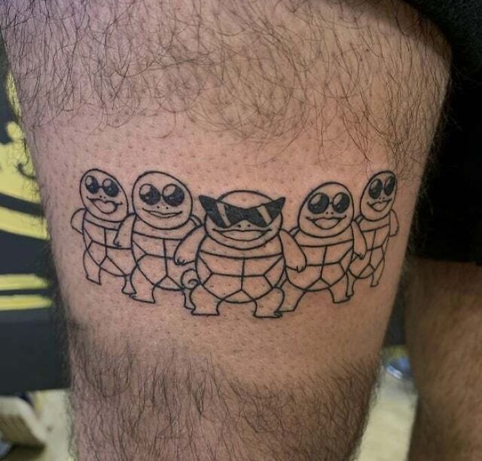 '90s culture tattoo of cartoon turtles wearing sunglasses on a person's leg.
