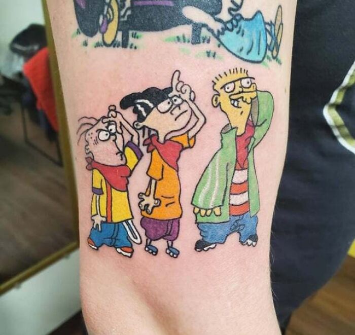 '90s culture tattoo featuring cartoon characters on an arm.