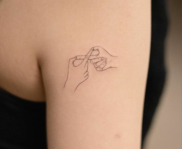 Line art infinity tattoo on arm, symbolizing eternal creativity.