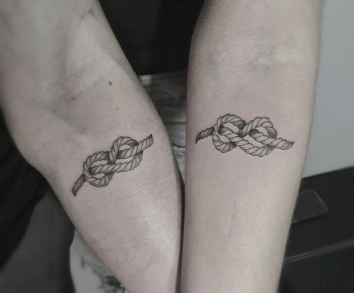 Infinity tattoos featuring knotted rope design on both arms, symbolizing creativity.