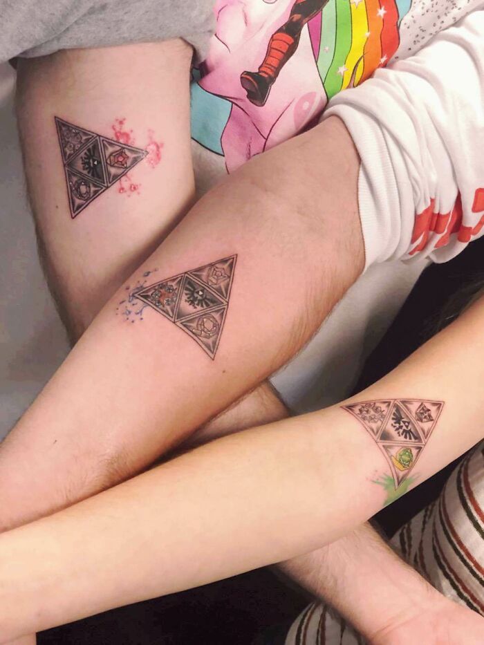 Three arms with matching triangle The Legend Of Zelda video game tattoos, showcasing unique designs for gamers.