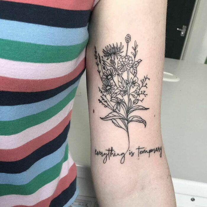 Floral design tattoo with "everything is temporary" text, symbolizing mental health healing.