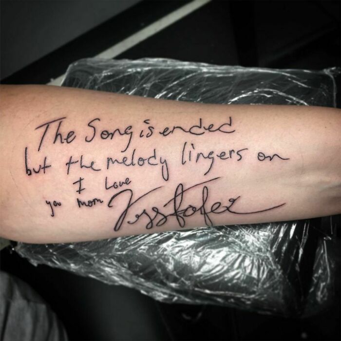 Handwriting tattoo on arm memorializing family with a sentimental quote.