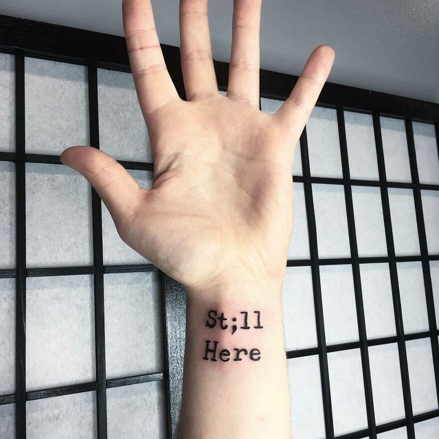 'still here' phrase with Semicolon tattoo 