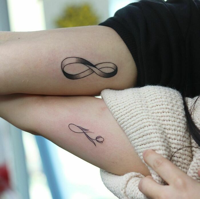 Two infinity tattoos on forearms, showcasing creativity and symbolism of eternity.