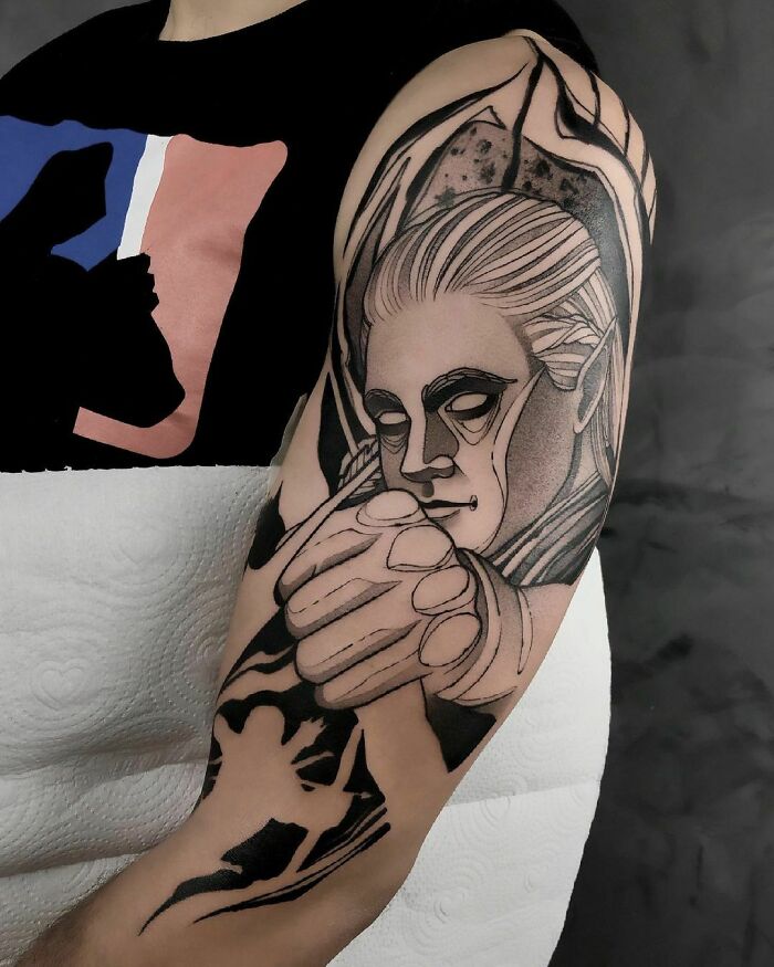 Tattoo of an elf with pointed ears on arm, inspired by Lord of the Rings.