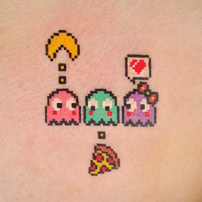 Pixelated Pac-Man video game tattoo with colorful ghosts, Pac-Man, and pizza slice, perfect for hardcore gamers.