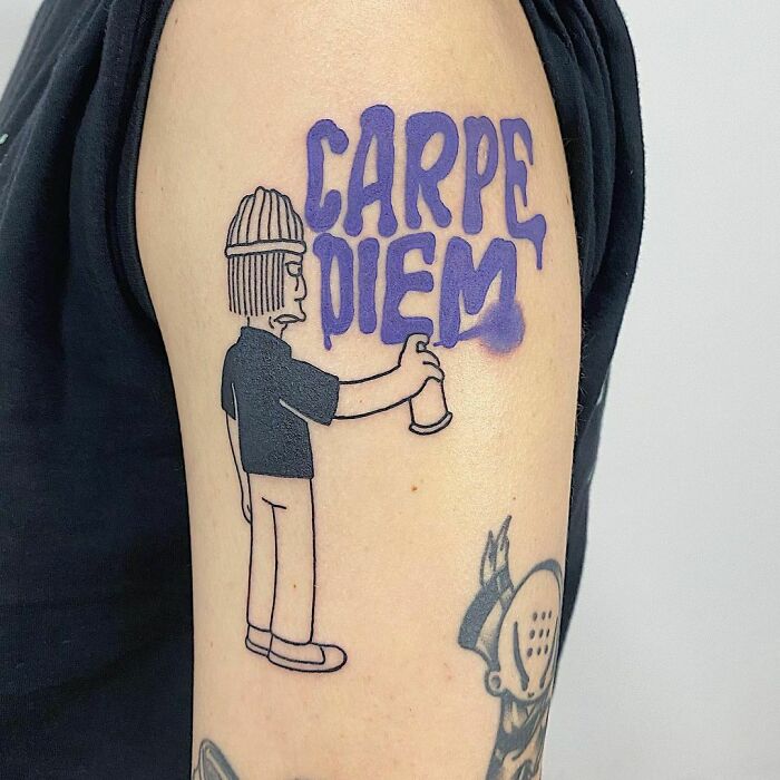 Tattoo of character spray painting "Carpe Diem," symbolizing powerful mental health messages.