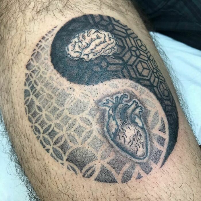Yin Yang tattoo with brain and heart imagery, symbolizing life's duality.