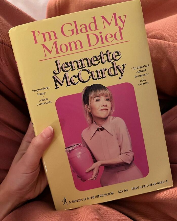 Jennette McCurdy's book cover, "I'm Glad My Mom Died," held in a reader's hand. Jennette McCurdy's book cover, "I'm Glad My Mom Died," held in a reader's hand.