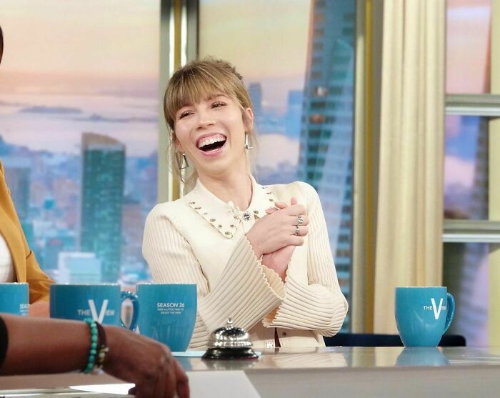 Person laughing on a talk show set, discussing a personal story about their mom. Person laughing on a talk show set, discussing a personal story about their mom.