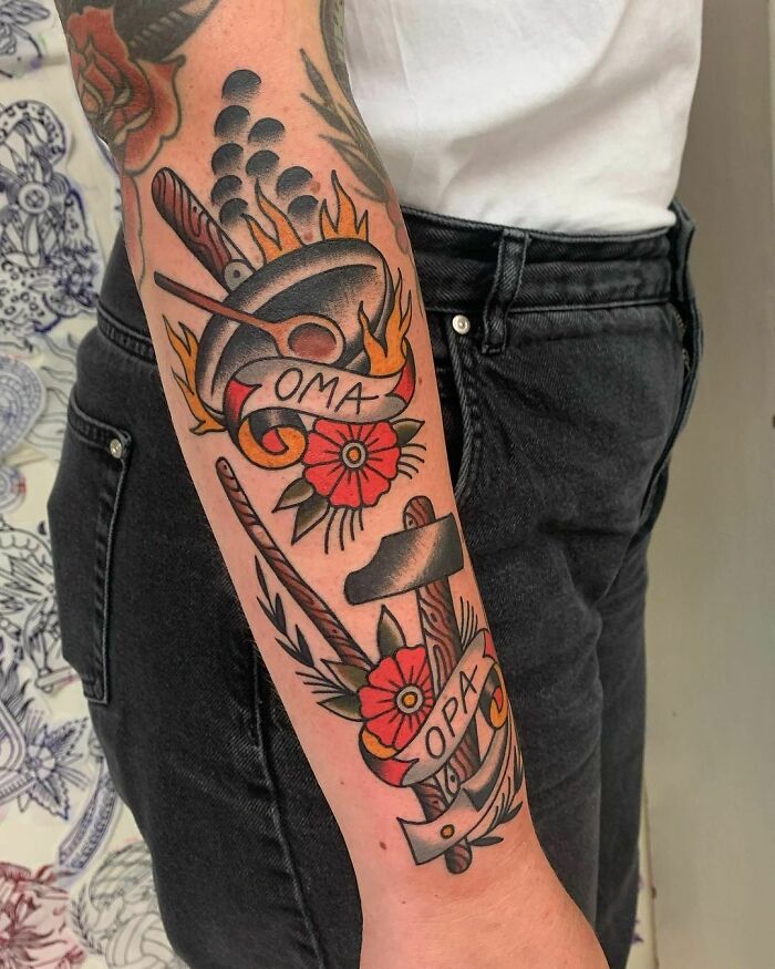Arm with memorial tattoo design featuring flowers and kitchen tools labeled "Oma" and "Opa" to honor family.