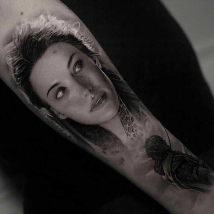 Realistic Lord of the Rings tattoo featuring a woman's face and cloaked figure on a forearm.