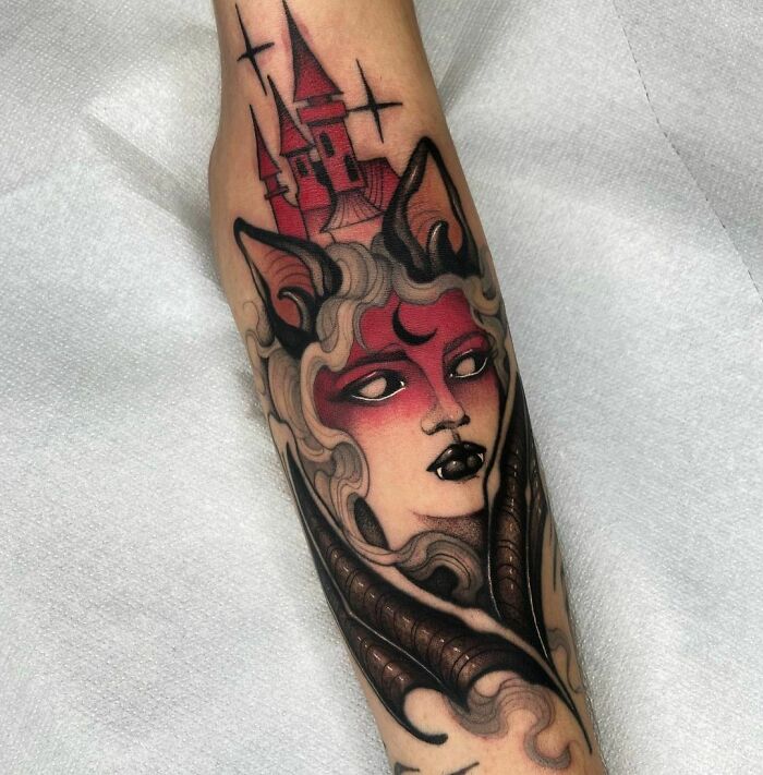 Gothic tattoo with a mystical woman, castle, and crescent moon on a forearm, showcasing vibrant and dark colors.