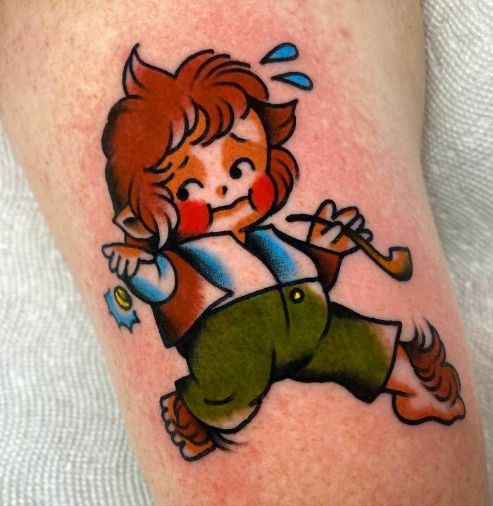 Cartoon Hobbit tattoo with pipe and ring, inspired by Lord of the Rings.