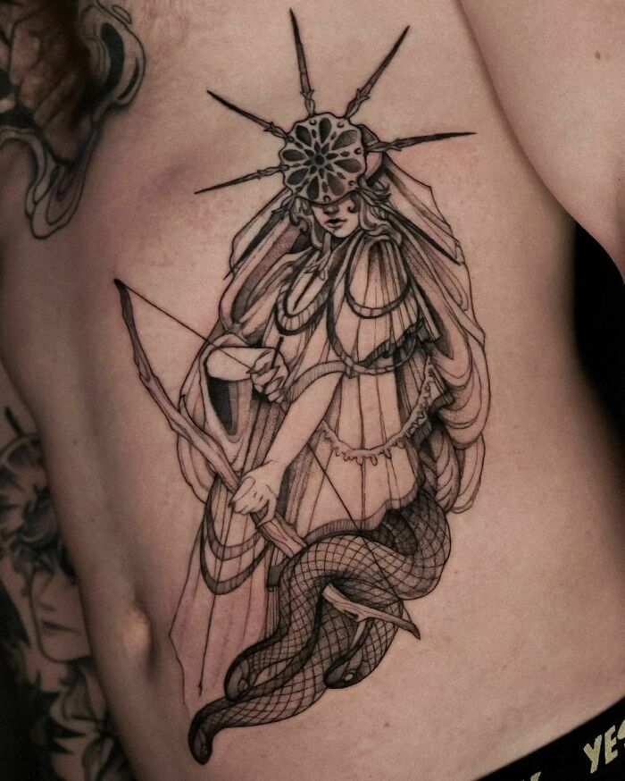 Dark Souls video game tattoo of an archer with a serpent body and ornate headpiece on a person's side.