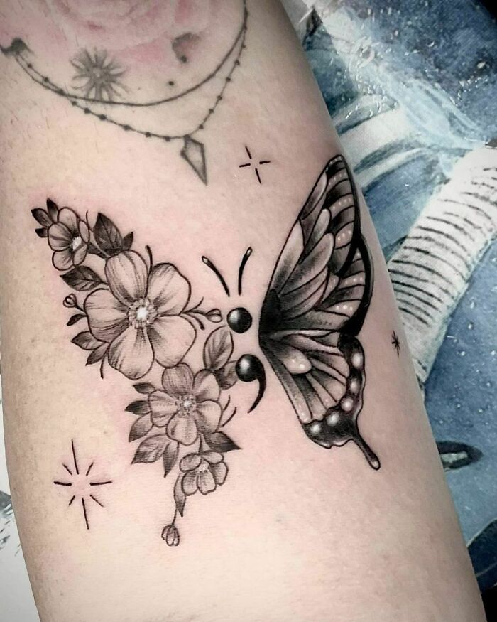 Butterfly and floral mental health tattoo symbolizing healing and transformation.