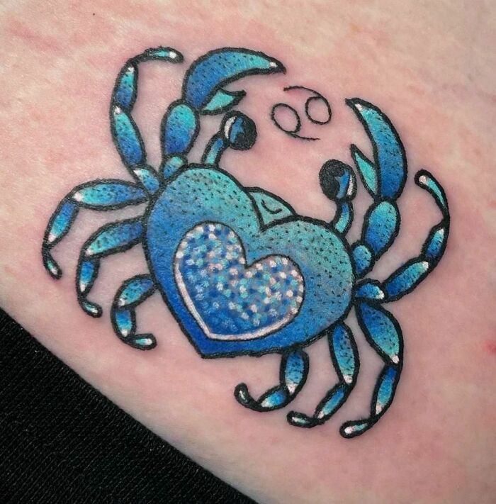 Blue crab zodiac tattoo with heart design, symbolizing Cancer, showcasing unique and vibrant astrological art.