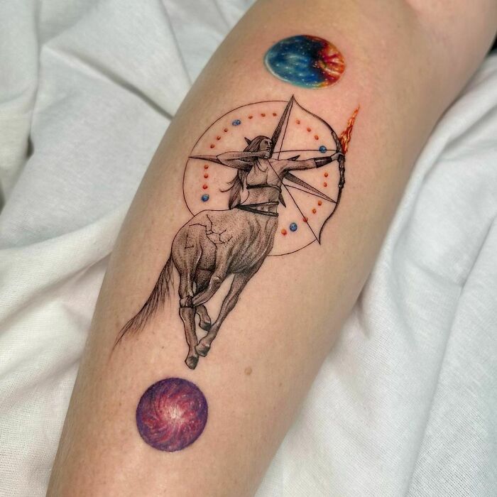 Zodiac tattoo of a centaur archer with planets, showcasing Sagittarius design.