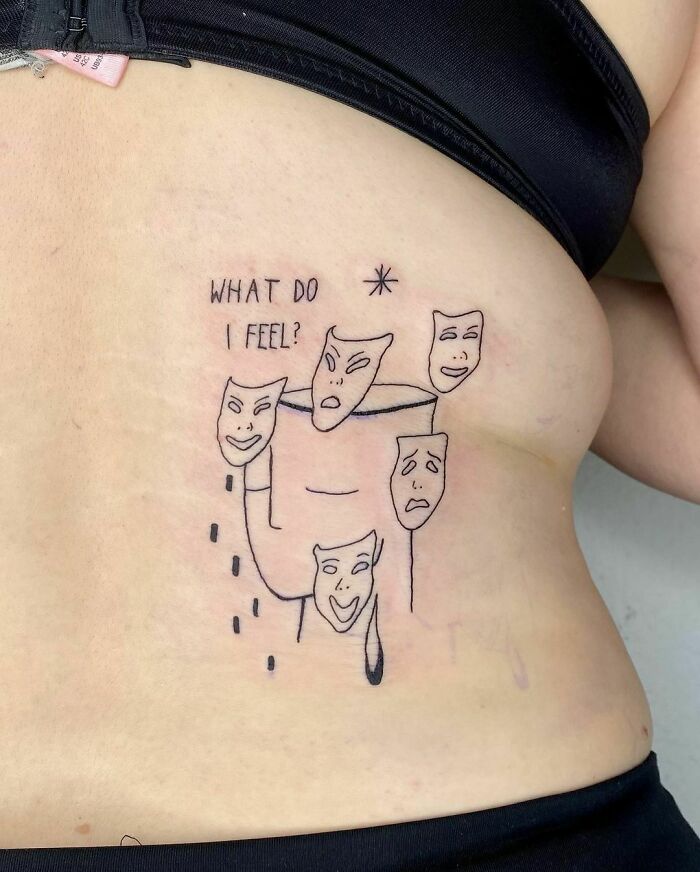 Minimalist mental health tattoo with expressive masks and the phrase "What do I feel?" on a person's side.