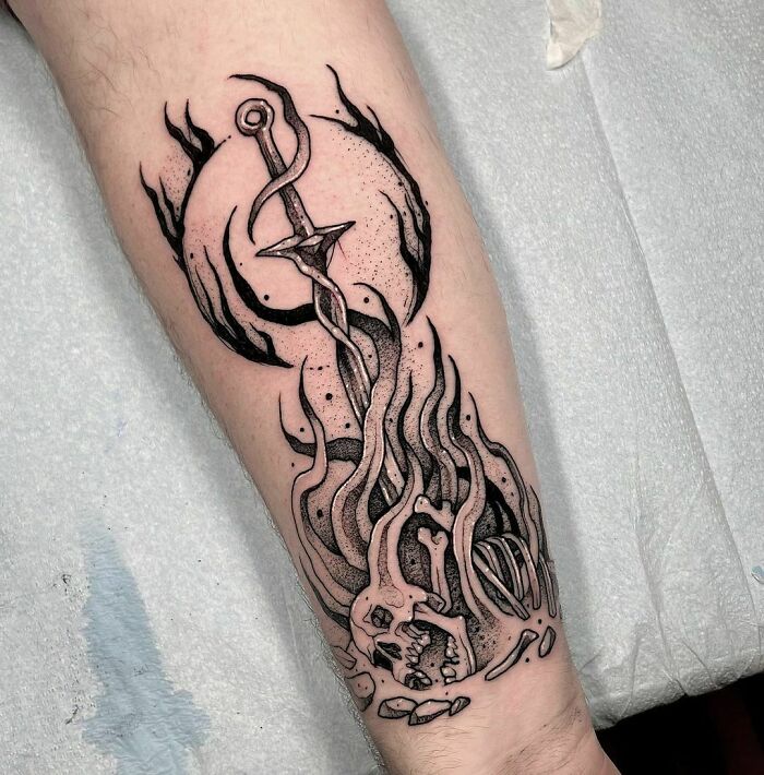 Intricate black and gray Dark Souls video game tattoo featuring a sword and skull, perfect for hardcore gamers.