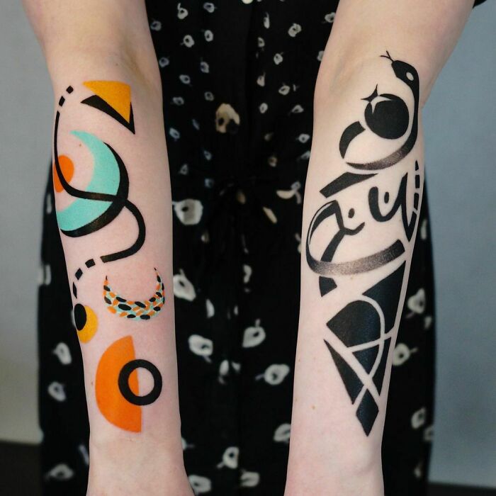 Abstract tattoo designs on forearms showcasing colorful geometric shapes and black patterns.