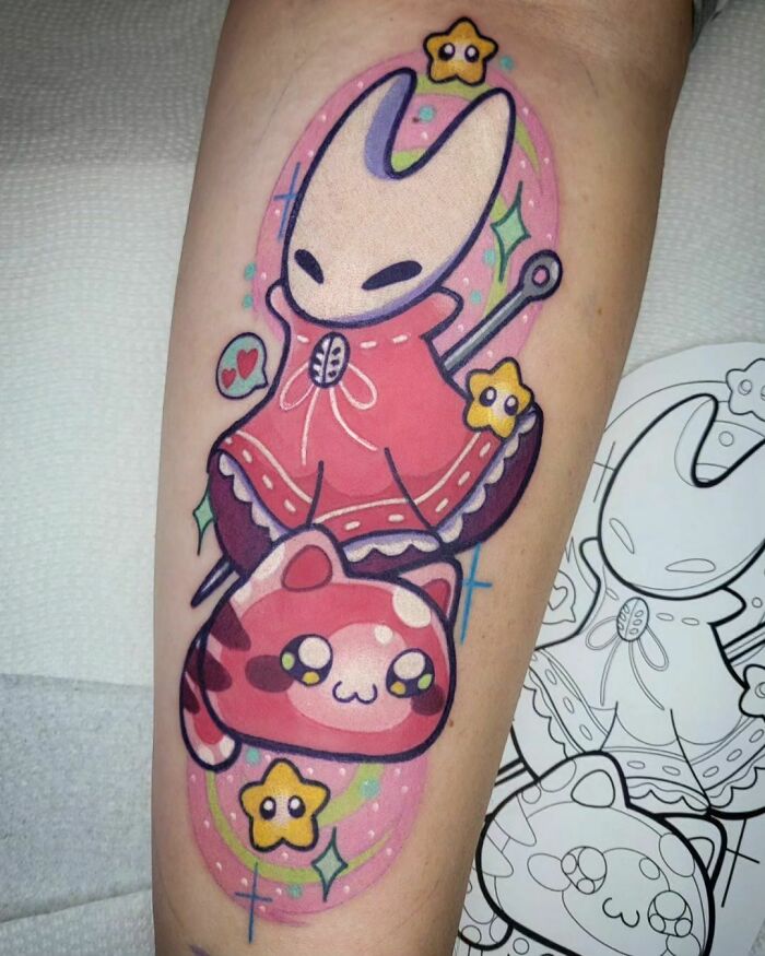 Cute Hollow Knight video game tattoo featuring a vibrant character and cat design with stars on forearm.