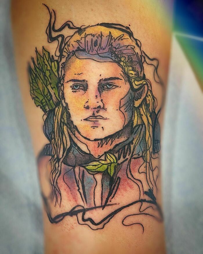 Colorful Lord of the Rings tattoo featuring a detailed portrait with arrows in the background.