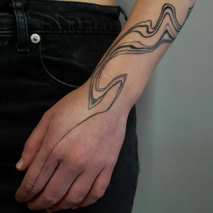 Abstract tattoo design on forearm, showcasing artistry and self-expression.