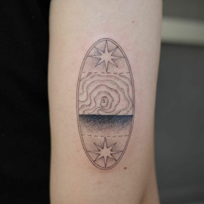 Abstract tattoo design with stars and geometric patterns on an arm, showcasing artistry and self-expression.