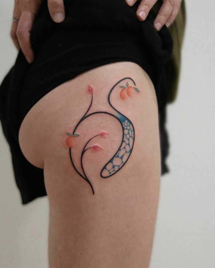 Abstract tattoo with floral design and geometric patterns on the thigh, showcasing artistry and self-expression.