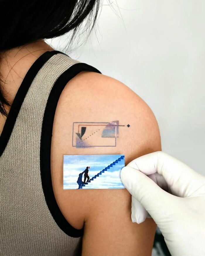 Abstract tattoo on shoulder, featuring geometric and surreal elements, showcasing artistry and self-expression.