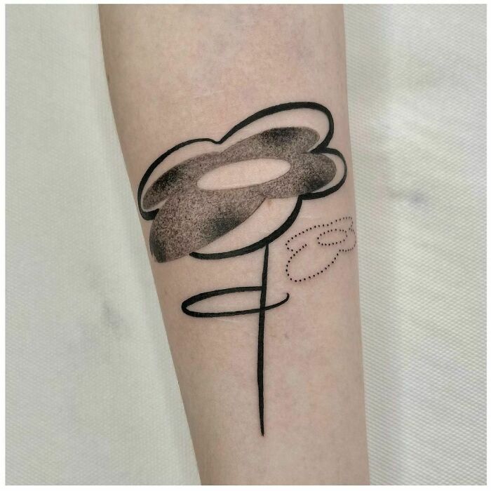 Abstract tattoo with bold lines and shaded shapes on forearm reflecting artistry and self-expression.