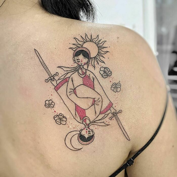 Abstract tattoo featuring dual figures with swords, sun, and moon motifs on a person's shoulder.