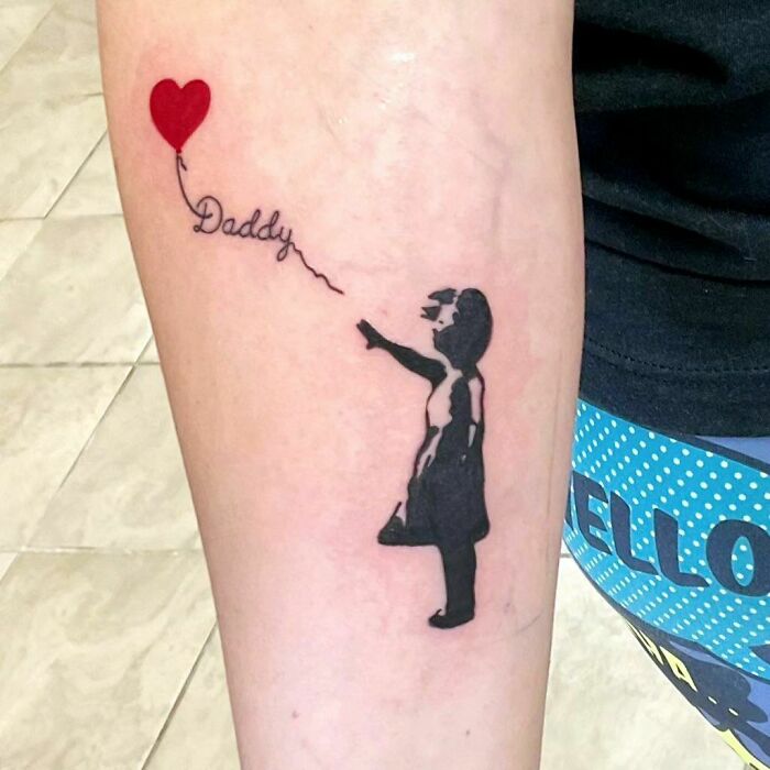 Memorial tattoo of a silhouetted child reaching for a red heart balloon with "Daddy" written on it.