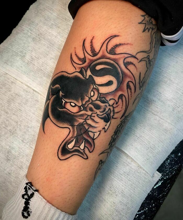 Dragon and yin yang tattoo on leg, symbolizing the duality of life.
