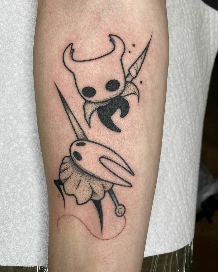 Hollow Knight video game tattoo featuring characters from Hollow Knight, inked on a forearm.