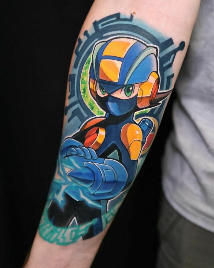 Colorful Mega Man video game tattoo on forearm featuring a futuristic character design.