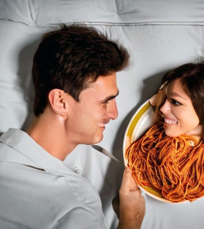 Man smiling at a woman's face humorously placed among spaghetti, showcasing AI art fails.