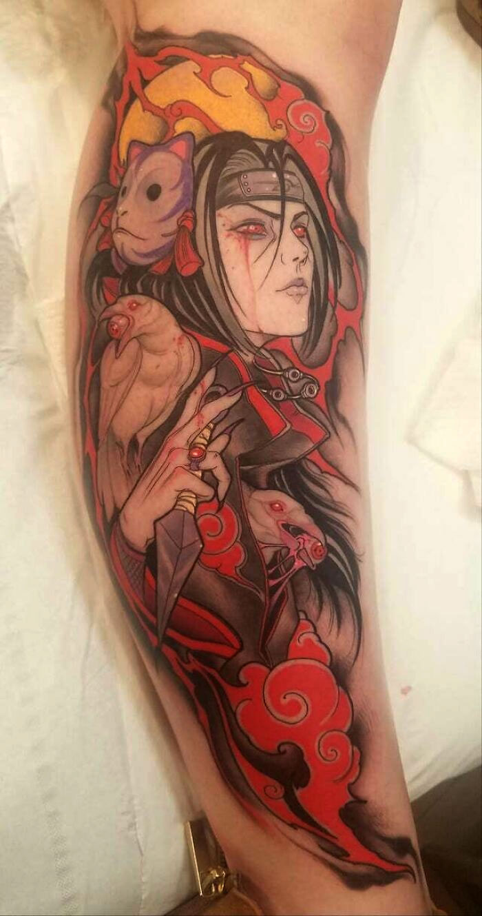 Anime tattoo featuring a stylized character in red and black, highlighting intricate design elements and bold colors.