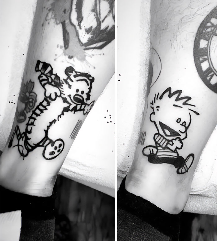 Ankle tattoo featuring Calvin and Hobbes characters in black ink.