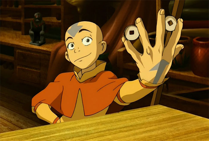 Aang from Avatar The Last Airbender holding coins with a confident expression in a wooden room setting.