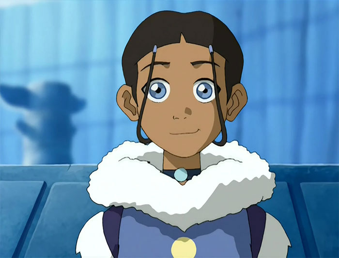 Katara from Avatar The Last Airbender looking sincere in winter clothing with a fur collar in animated style